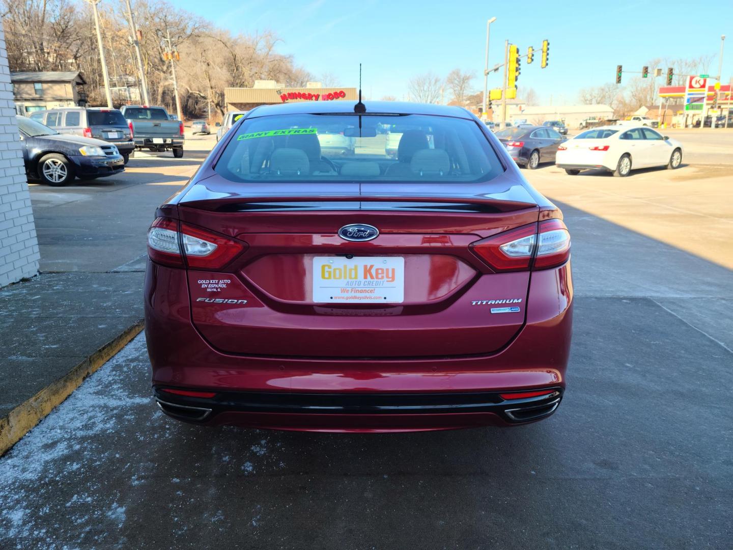 2016 Ruby Red Metallic Tinted Clearcoat /Charcoal Black, Leather Ford Fusion Titanium AWD (3FA6P0D98GR) with an 2.0L L4 DOHC 16V engine, 6A transmission, located at 104 1st Avenue, Silvis, IL, 61282, (309) 755-9511, 41.515156, -90.425377 - Photo#1